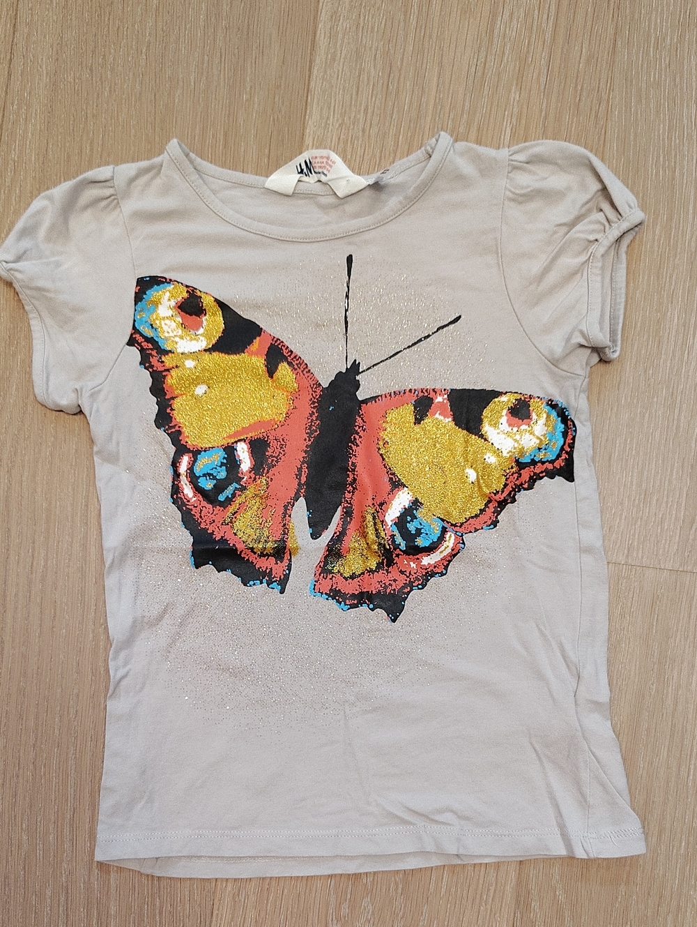 H&M Beige Toned Kids Top with Black Graphic and Gold Glitter